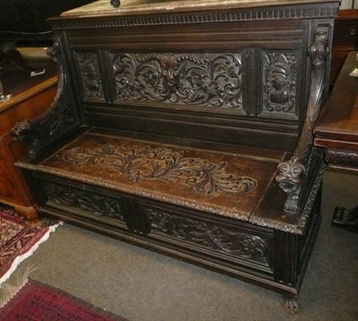 Lot 753 - A Victorian carved oak settle with hinged seat