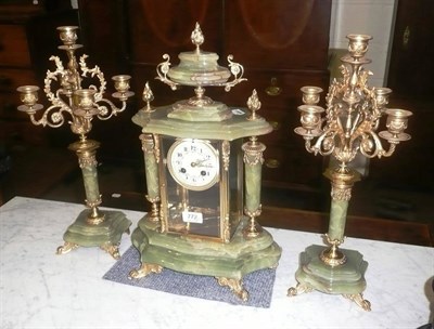 Lot 772 - A green onyx striking mantel clock with garniture