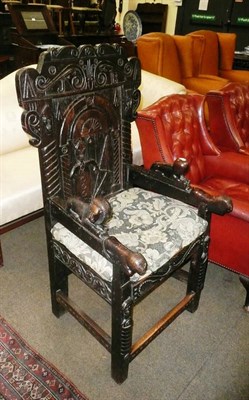 Lot 777 - A carved oak elbow chair