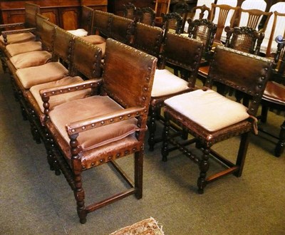 Lot 802 - A set of twelve oak Cromwellian style dining chairs in nailed hide