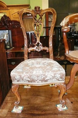 Lot 831 - A Victorian carved walnut nursing chair