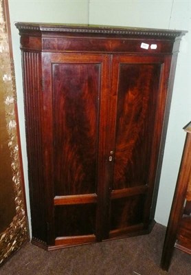 Lot 891 - A George III Mahogany Hanging Corner Cupboard, early 19th century, the dentil cornice above...