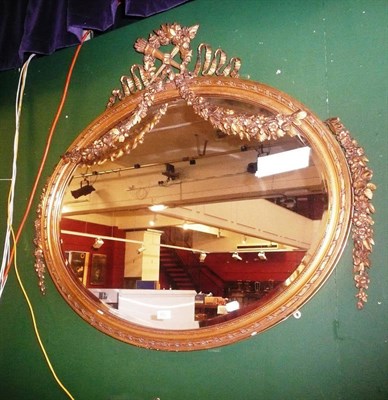 Lot 902 - An elaborate late 19th century gilt oval wall mirror