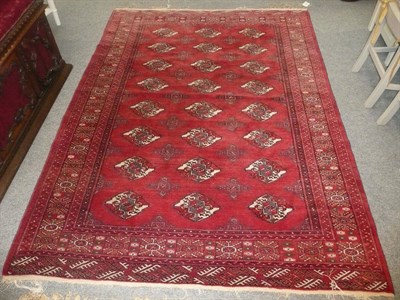 Lot 974 - Persian small carpet in Turkoman style with claret field