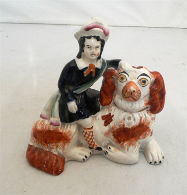 Lot 14 - A Staffordshire model of a spaniel mounted with a woman