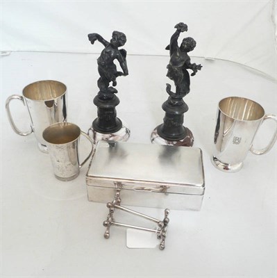 Lot 23 - A silver cigarette box, three plate tankards, two knife rests and a pair of bronze figures
