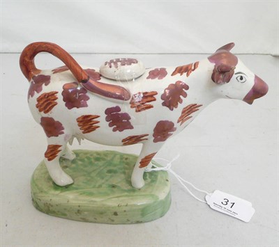 Lot 31 - A 19th century lustre cow creamer