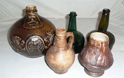 Lot 83 - Two green glass onion wine bottles and three stoneware Bellamine flagons