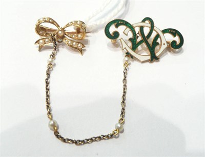 Lot 97 - A seed pearl bow brooch and green and white enamelled attachment of entwined initials 'CM'