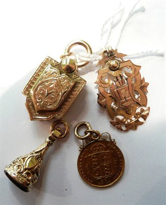 Lot 122 - A 9ct gold shield (previously adapted) a seal fob, a coin (cast) and a plated double locket