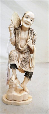 Lot 135 - Carved ivory figure of a gent holding a fan