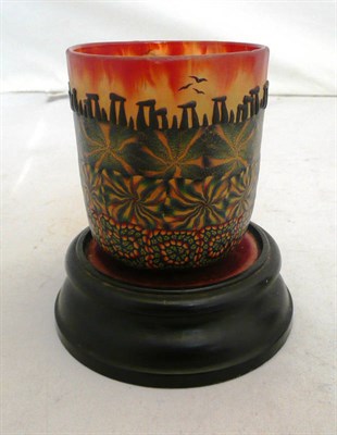 Lot 143 - A decorative painted glass night light cover on ebonised stand