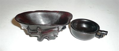 Lot 145 - A carved wooden libation cup and another smaller