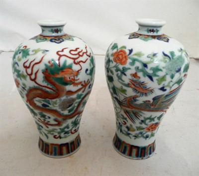 Lot 148 - A pair of Chinese Doucai porcelain vases, of baluster shape,  one enamelled with a phoenix...