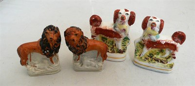 Lot 161 - Pair of small Staffordshire lions and similar pair of spaniels (4)