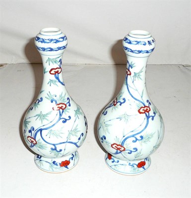 Lot 205 - A pair of Chinese Doucai porcelain pedestal vases, decorated with bamboo and scrolling tendrils...