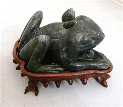 Lot 218 - A Chinese green soapstone frog joss stick holder on root wood stand