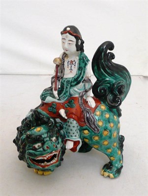 Lot 220 - A Japanese enamelled porcelain figure of Fugen Bosatsu on shi-shi, possibly Kaya Kilns