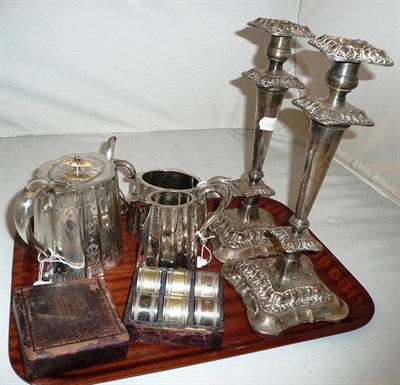 Lot 239 - A pair of old Sheffield plate candlesticks, a three piece tea service and six cased napkin rings