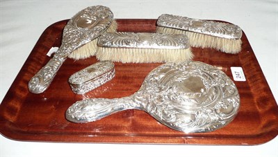 Lot 247 - Four silver dressing table items and a fitted silver ring case