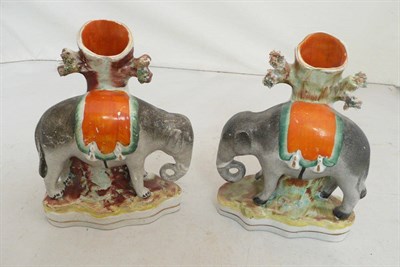 Lot 250 - A pair of Staffordshire elephant spill vases