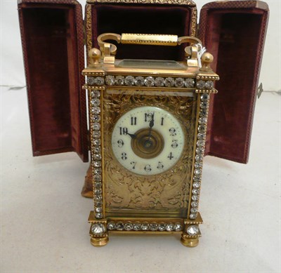 Lot 252 - A cased decorative timepiece with key