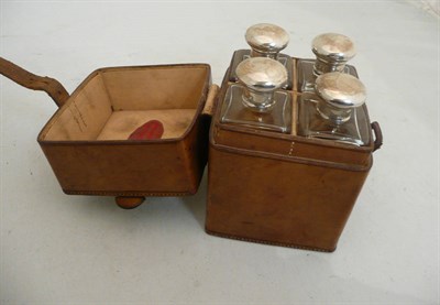 Lot 254 - Leather cased set of four silver topped bottles