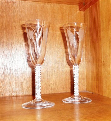 Lot 324 - A pair of 18th century ale glasses with double series opaque twist stems, the bowls etched with...