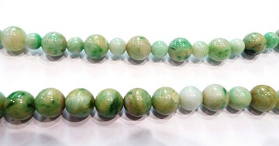 Lot 354 - A string of round jade type beads (on a wire with base metal clasp)