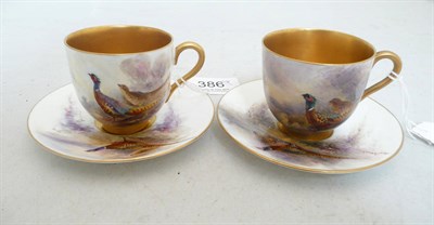 Lot 386 - Two Royal Worcester cups and saucers, painted by Jas Stinton with pheasants