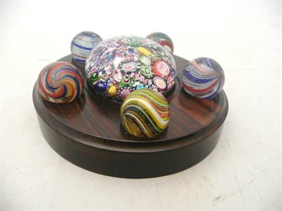 Lot 448 - French paperweight and five marbles on a wooden stand