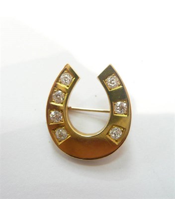 Lot 463 - A diamond set horseshoe brooch, seven old cut diamonds set into a plain polished yellow gold mount