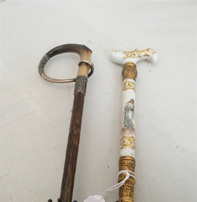 Lot 478 - A black parasol with a painted porcelain and gilt metal handle and another with horn and silver...