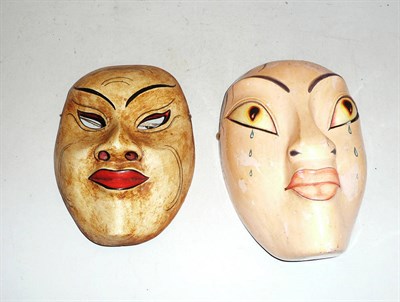 Lot 480 - A carved and painted Oriental style face mask and another similar