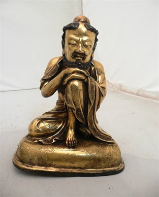 Lot 502 - A gilt bronze figure of a crouched lohan in Qing Dynasty style