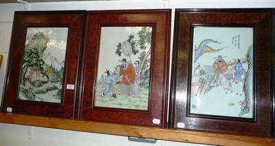 Lot 557 - Three Chinese porcelain wall plaques - 20th century, two with figurative scenes, the other with...