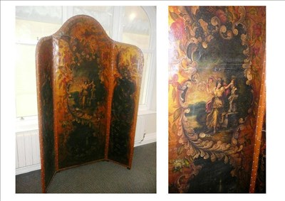 Lot 625 - A painted leather screen of three leaves with an arched centre, painted all over with floral...