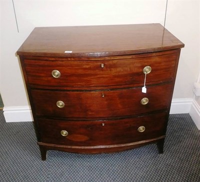 Lot 629 - A Regency mahogany and ebony strung bowfront dressing chest, circa 1820, the hinged lid with reeded