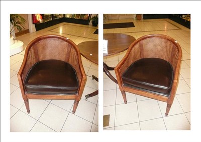 Lot 638 - Pair of oak framed bergere tub armchairs with brown leather seats