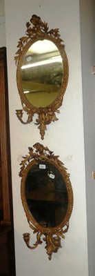 Lot 642 - A pair of gilt framed oval girandoles carved with a dragon