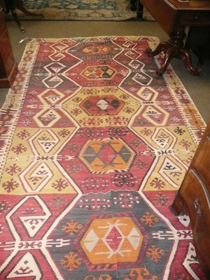 Lot 671 - Anatolian Kilim, the polychrome field with seven linked hexagons enclosed by serrated leaf borders