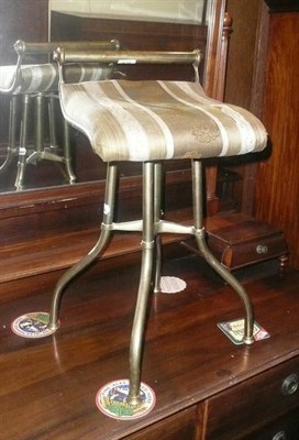 Lot 678 - A brass revolving piano stool