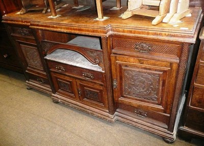 Lot 689 - A 19th century large carved walnut break front sideboard