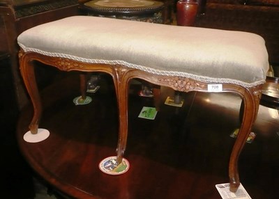 Lot 708 - A French style walnut double stool with green velvet upholstered top