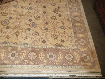 Lot 715 - A good Indian carpet, the beige field with an allover floral lattice design enclosed by rosette and