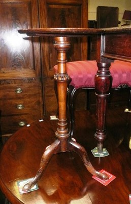 Lot 718 - A walnut occasional table, the burr veneered dished top raised on a turned pillar with fluted...