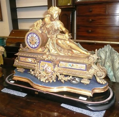 Lot 727 - A gilt metal and porcelain mounted mantel clock with two bases