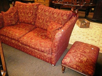 Lot 730 - Bryn Hall knoll settee in red ground floral fabric with footstool