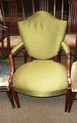 Lot 734 - A walnut famed open arm chair, upholstered in green