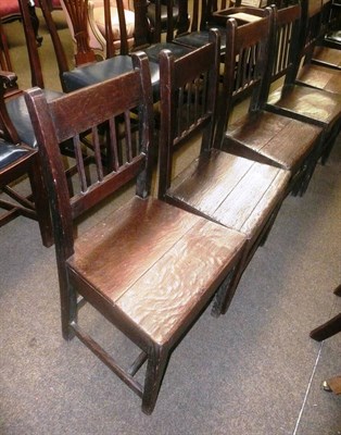 Lot 749 - Harlequin set of six oak country chairs with boarded seats